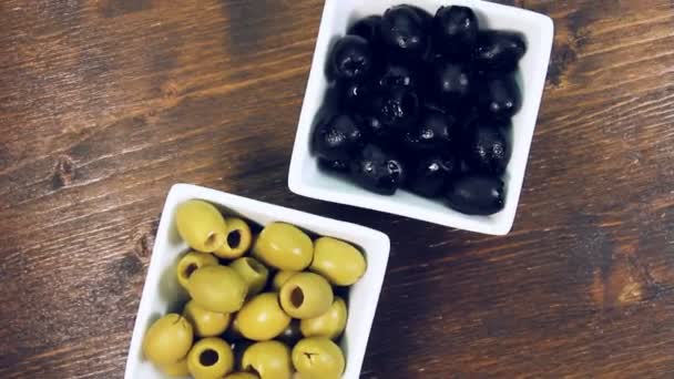 Green Black Olives Square Bowl Wooden Table Rotating View — Stock Video