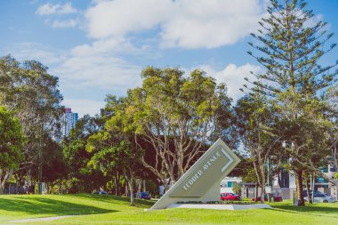 GOLD COAST, AUSTRALIA - January 7th, 2015: tropical trees and high-rise buildings in Surfers Paradise near the Tedder Avenue area clipart