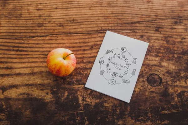 apple and healthy food note on memo paper on wooden table, concept of nutrition and diet