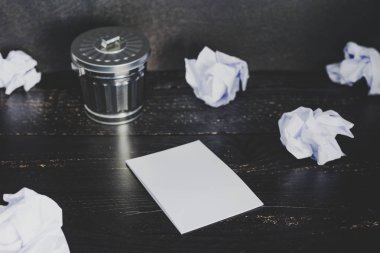 Çöp kutusu Resepsiyon ayarıyla boş not defteri ve buruşuk Kağıt topları, hazırlanması ve belgeler yazmak için mücadele kavramı üzerinde