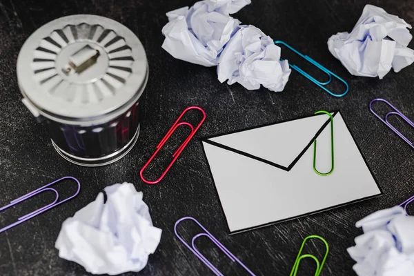 envelope with clip symbol of email and attachments with trash can next to it, concept of spam and unwanted emails