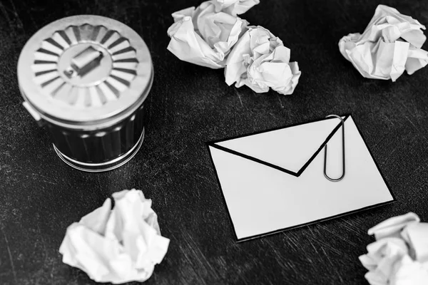 envelope with clip symbol of email and attachments with trash can next to it, concept of spam and unwanted emails