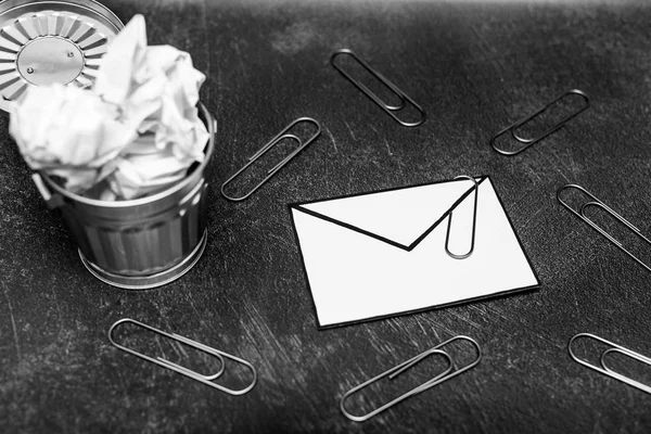 envelope with clip symbol of email and attachments with trash can next to it, concept of spam and unwanted emails