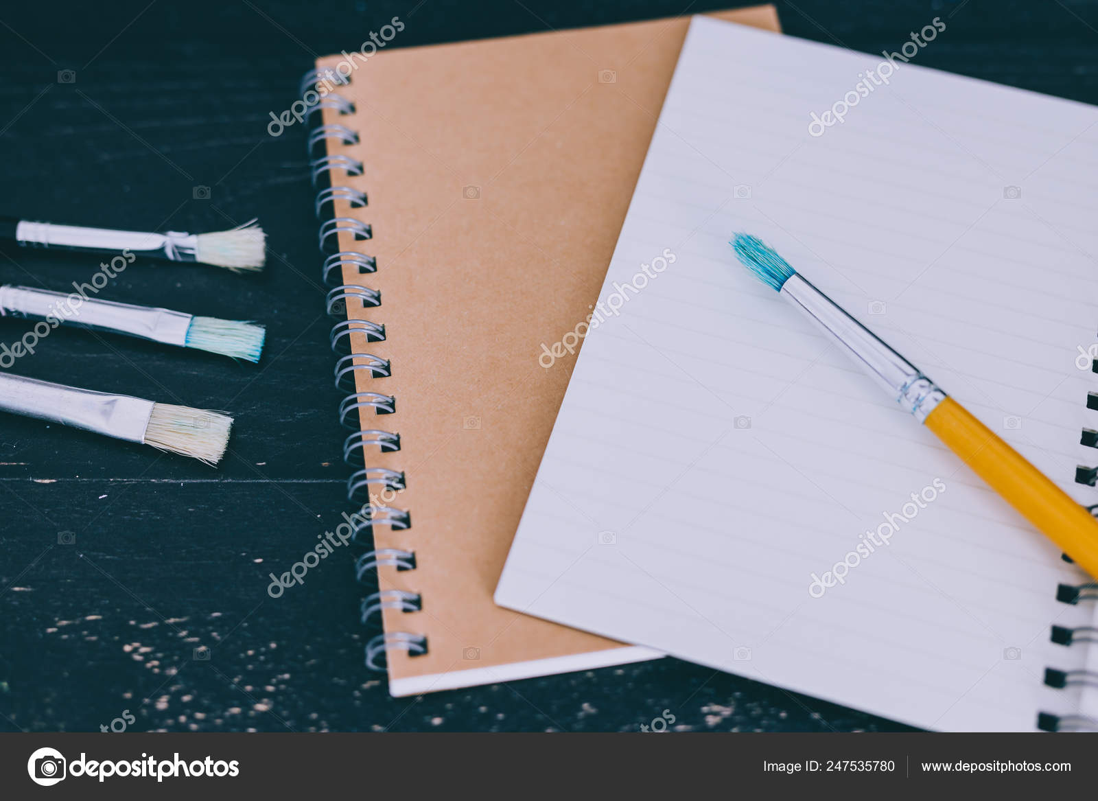 Desk With Notepads And Watercolour Brushes With Empty Pages And