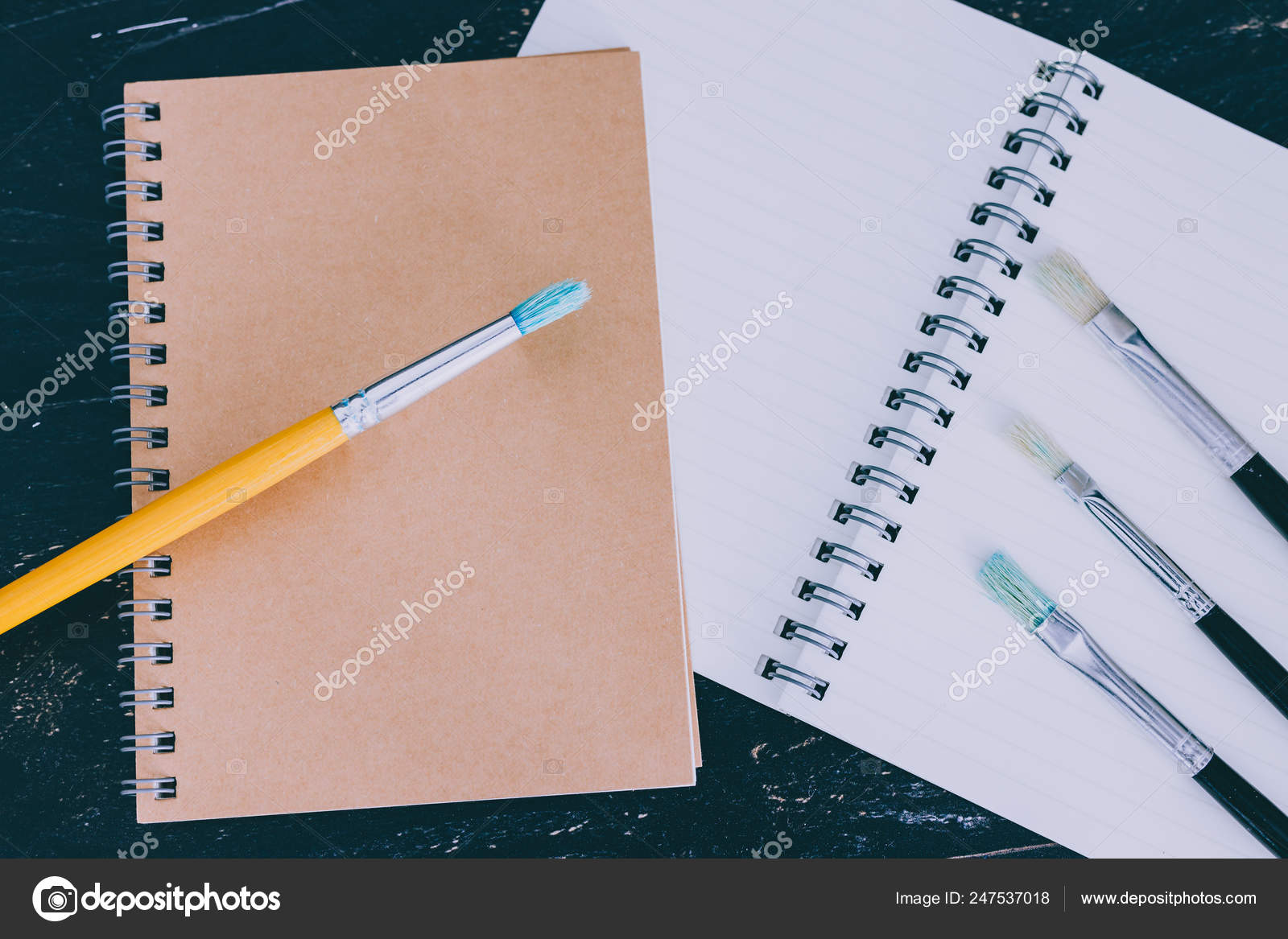 Desk With Notepads And Watercolour Brushes With Empty Pages And