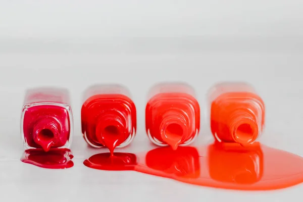 nail polish bottles in different shades of red to orange and pur