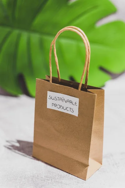 paper shopping bag with Sustainable Item label on it on leaf and