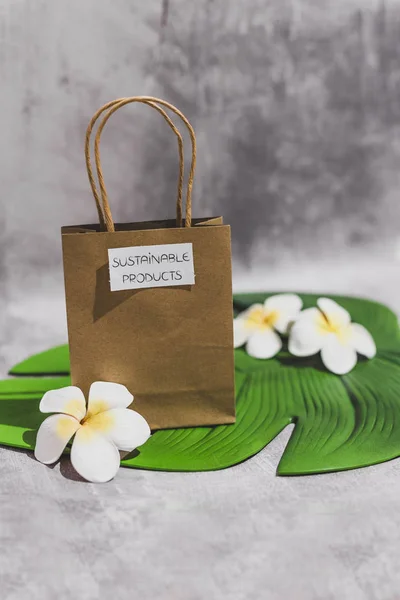 paper shopping bag with Sustainable Item label on it on leaf and