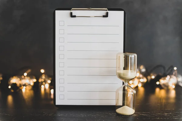 clipboard with blank list with cases to tick off on wooden desk