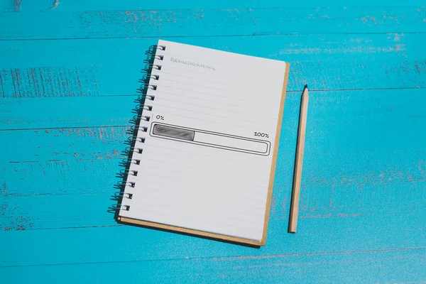 notebook with Brainstorming title on page and progress bar loadi