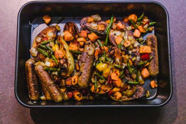 vegan sosis patates ve karışık kavrulmuş veggi ile fırın tepsisi