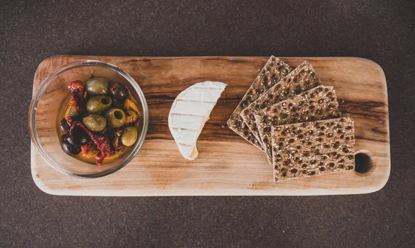 vegetarian platter with olives cheese and multigrain crackers