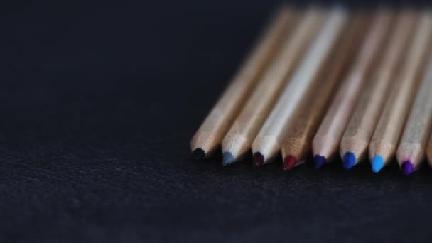 Coloured Pencils Lined Dark Desk Close Camera Panning Horizontally Left — Stock Video