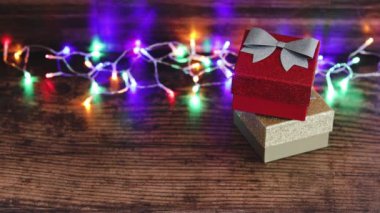 Xmas sunar konsept el alışveriş sepetini peri ışıkları arkaplanlı Noel hediyesi kutularının yanına yerleştirme