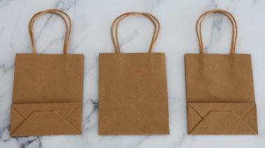 Covid-19 virüsü salgınından kaynaklanan küresel tecrit sonrasında şirketlere yardım etmek, alışveriş poşetlerinin üstüne ev mesajları koymak,