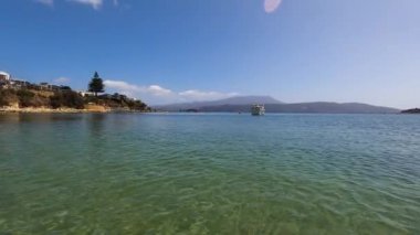 OPOSSUM BAY, TASMANIA - 16 Şubat 2020: Güneşli bir yaz günü Opossum Körfezi Sahili manzarası. Plajda derin mavi suyu ve açık gökyüzü olan hiç kimse yok.
