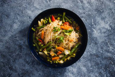 Sağlıklı bitkisel yemek tarifleri konsepti, vermicelli erişteli vejetaryen laksa çorbası ve kızarmış sebzeler.