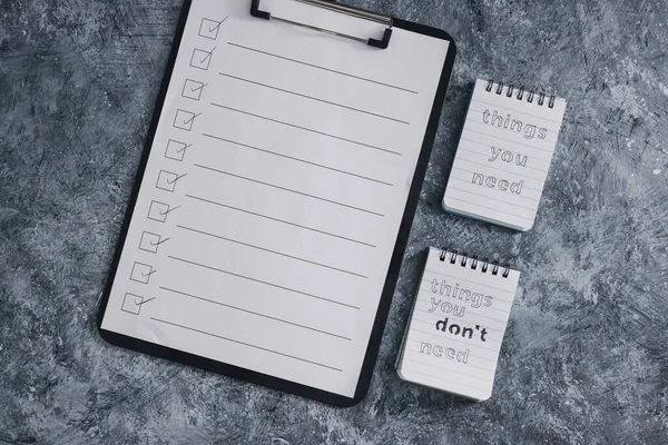 minimalism or self-improvement and introspection concept, notepads with texts Things you need and Things you dont need next to To Do list