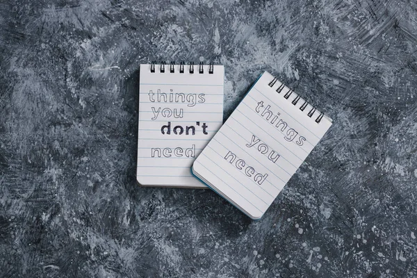 minimalism or self-improvement and introspection concept, notepads with texts Things you need and Things you dont need next to To Do list