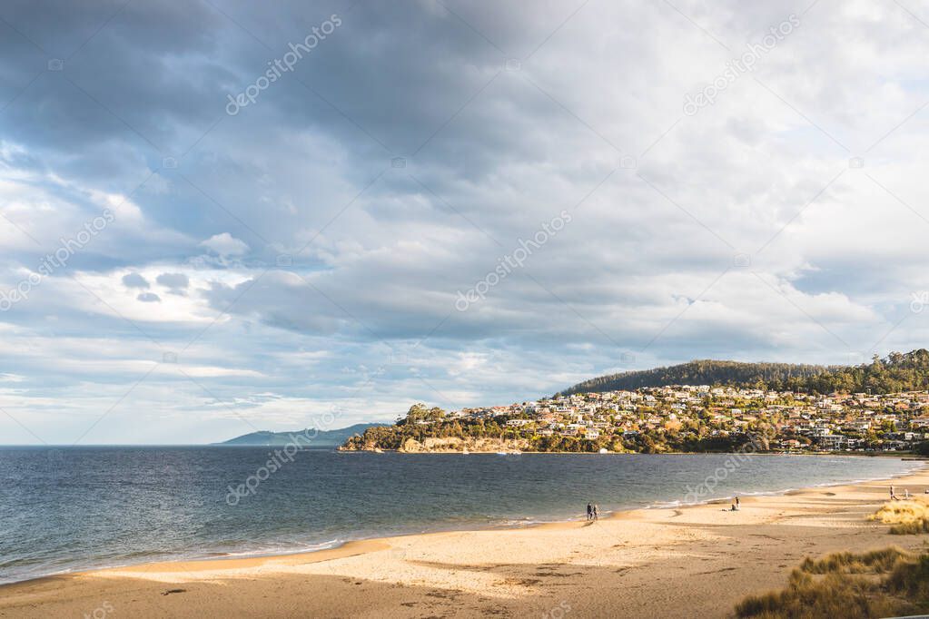 HOBART, TASMANIA - August 1stt, 2020: Blackmans Bay beach on a sunny winter day with few people at the beach, the area is an affluent suburb in South Hobart