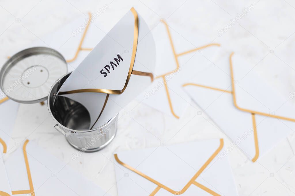 concept of inbox organisation and clean-up, spam email envelopes with trash can surrounded by other emails