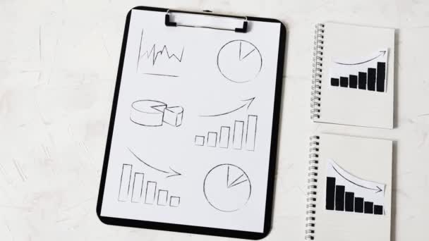 Statistikkonzept Positive Und Negative Trends Auf Grafiken Auf Notizbüchern Neben — Stockvideo