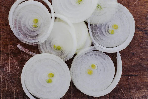Basit gıda malzemeleri konsepti, taze soğan kesim tahtasındaki halkalara kesilmiş.