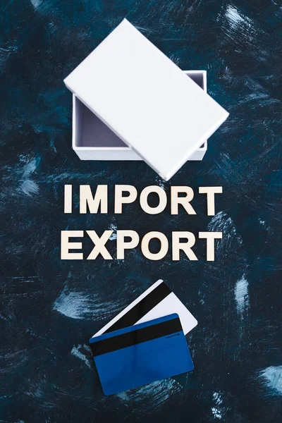 international trade and global business concept, Import Export text next to open parcel box with credit cards