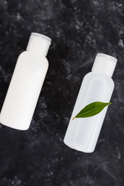 natural and cruelty-free beauty products concept, group of lotions and moisturizers with green leaves