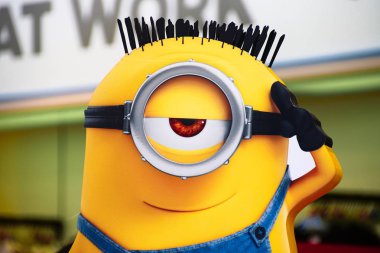 OSAKA, JAPAN - Jul 19, 2019 : Close up of HAPPY MINION statue, located in Universal Studios Japan. Minions are famous character from Despicable Me animation. clipart