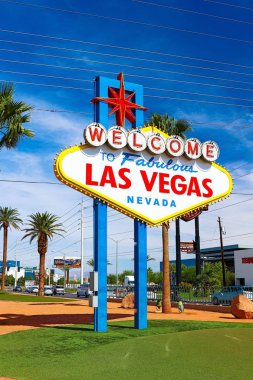 The Welcome to Fabulous Las Vegas sign on bright sunny day in Las Vegas.Welcome to Never Sleep city Las Vegas, Nevada Sign with the heart of Las Vegas scene in the background. clipart