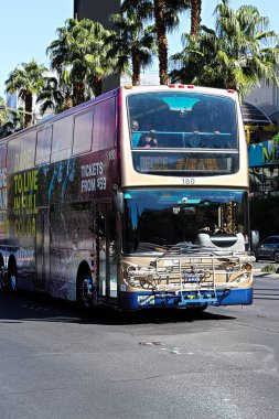 Las Vegas, NV/US - Sep 13, 2018: Double Decker Deuce bus public service driving on Las Vegas Boulevard. The bus is equipped with a bike rack and is carrying a bike. clipart