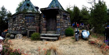Osaka, Japan - FEB 12, 2017 : Hagrid's motorbike and background home Hagrid at Universal Studios Japan.The Harry Potter is famous themed attractions in the Universal Studios Japan Theme Park. clipart