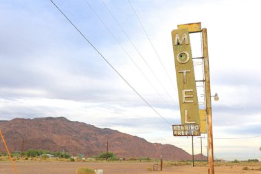 Old Motel sign ruin along historic Route 66 in the middle of California vast Mojave desert. clipart