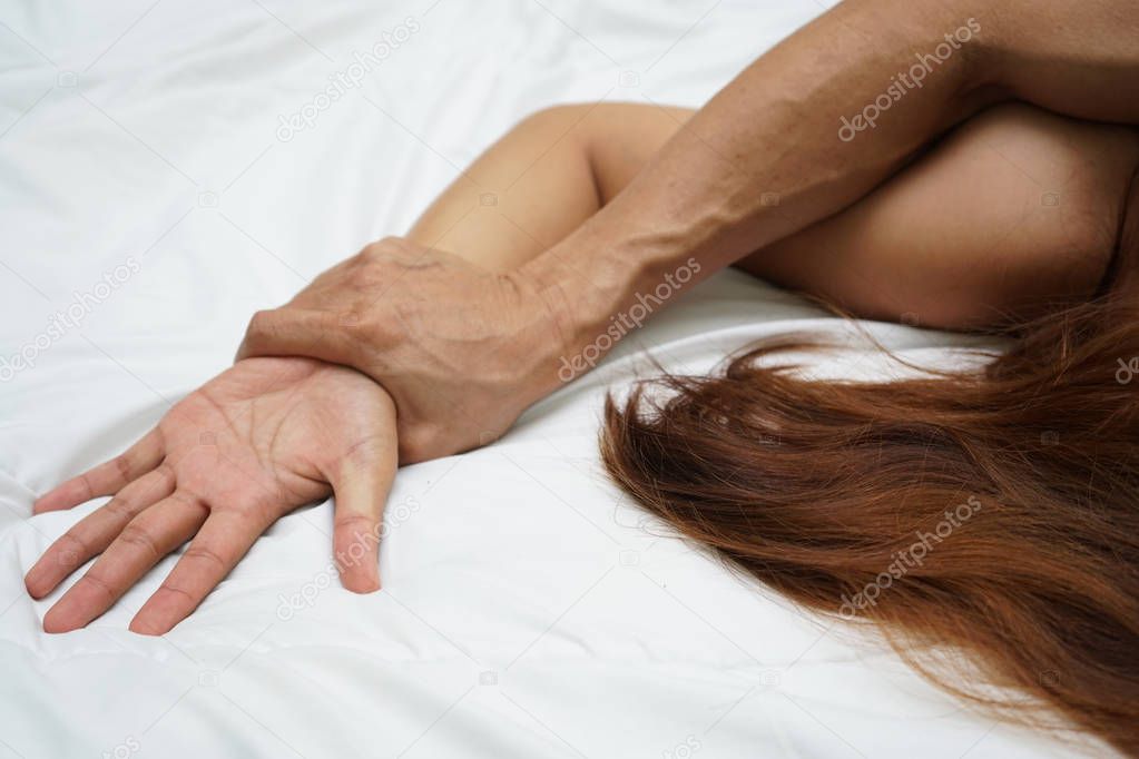 A hairy man's hand holding a woman hand for rape and sexual abuse concept                               