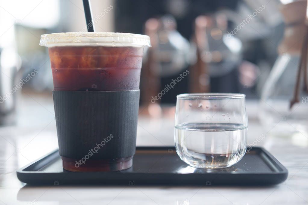 Close up ice of americano or black coffee served with water