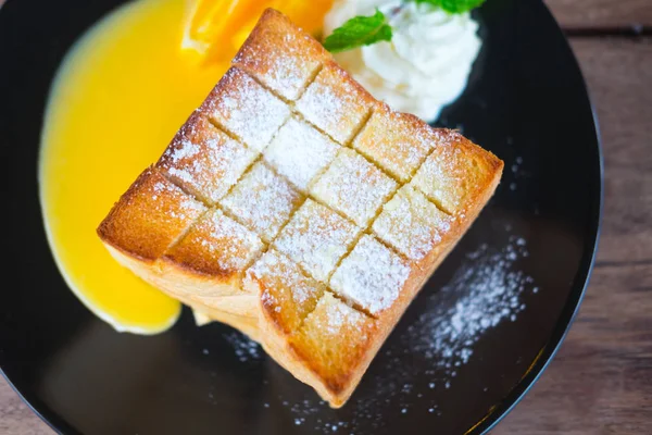 黒い皿の上にホイップ クリームと蜂蜜トースト — ストック写真