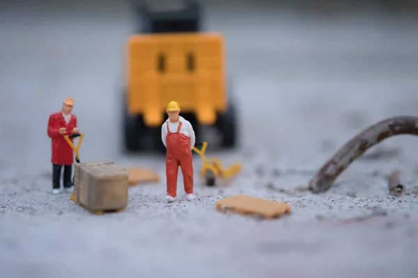 Miniature people delivery worker concept and industrial and logistic concept.