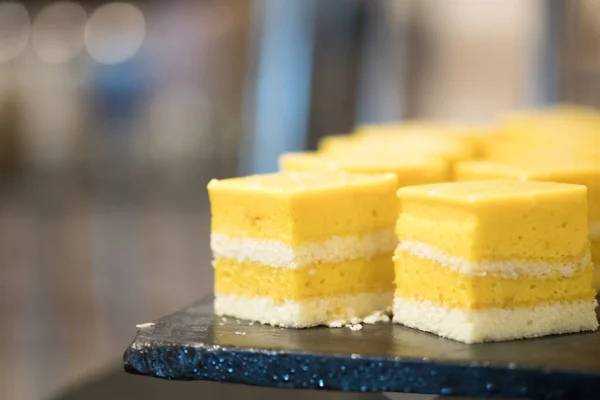 Delicious slice of yellow mango cake or fruit cake mango cake in sweet buffet