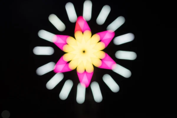 Blur in motion made with glow sticks neon light fluorescent on dark background.