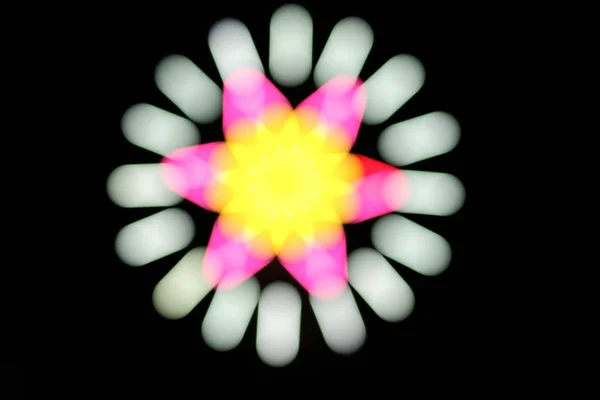 Blur in motion made with glow sticks neon light fluorescent on dark background.