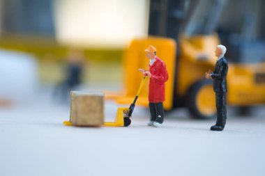 Minyatür iş adamı dağıtım depo fabrika ürünleri mal taşıyan işçilerin bak. Kargo ve nakliye kavramı