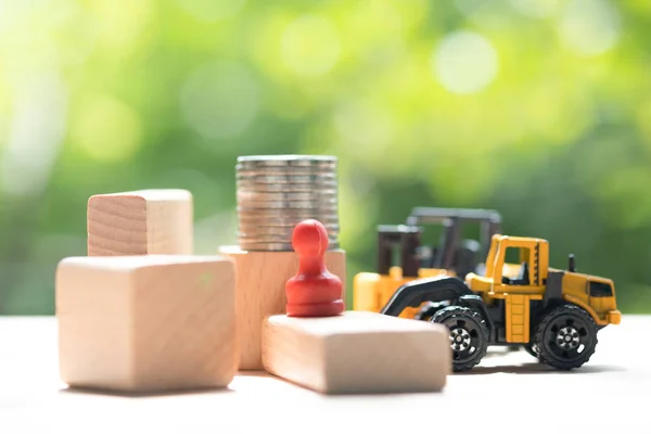 Construction truck models with coins. Real estate development or property investment. Home mortgage loan rate. Construction industry business concept