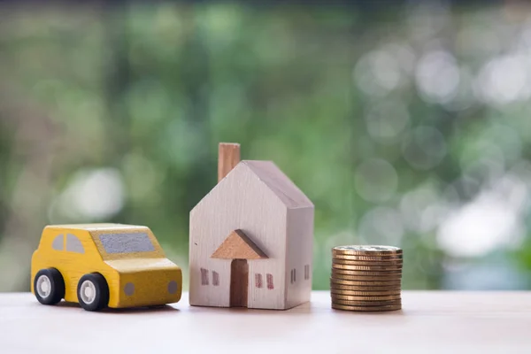 Wooden home, car with coins. Property mortgage, financial or insurance house, essentials for life ideas