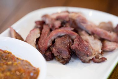 Izgara biftek dilimlenmiş ve beyaz çanak üzerinde Tay baharatlı sos, Tay gıda tarzı