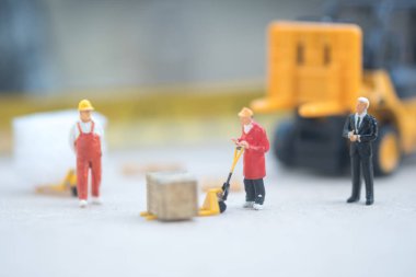 Minyatür iş adamı dağıtım depo fabrika ürünleri mal taşıyan işçilerin bak. Kargo ve nakliye kavramı