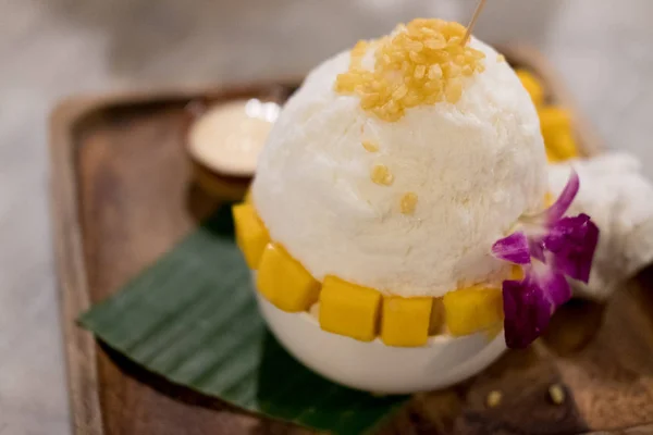 Mango Bingsu, shaved ice dessert with cubed sweet mango toppings. Bingsu Korea dessert