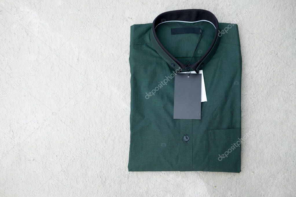 Close up of man green shirt with price tag