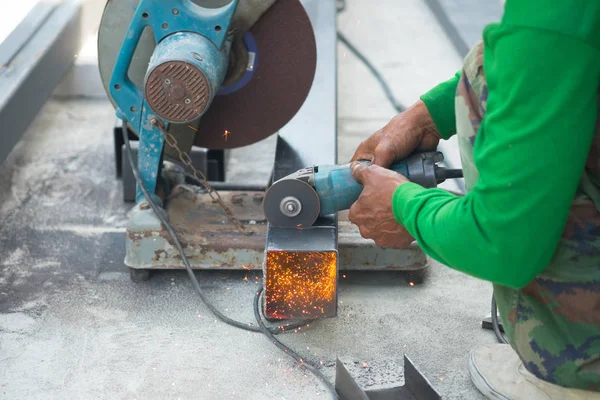 Worker cutting aluzinc metal sheet at building site construction. Industrial and Building construction concept.