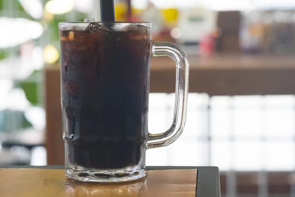 Thai iced black coffee signature local beverage on wooden background called oliang